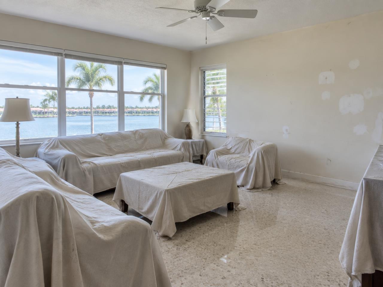 South Florida living room with scuffed and patched walls before painting